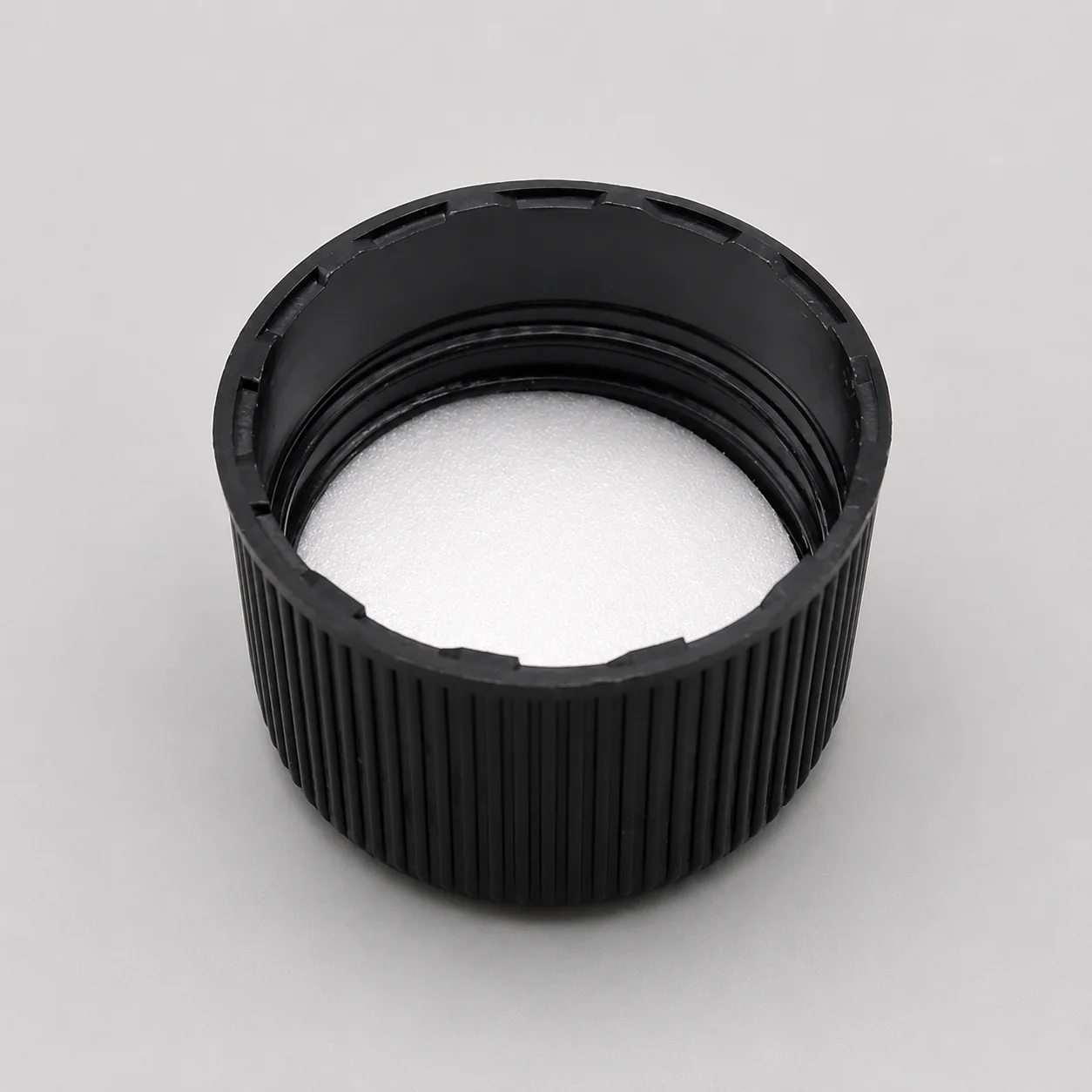 28 mm black bottle closure with a visible inner liner