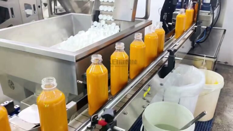 Automatic cap feeder supplying white screw caps for mango juice bottles