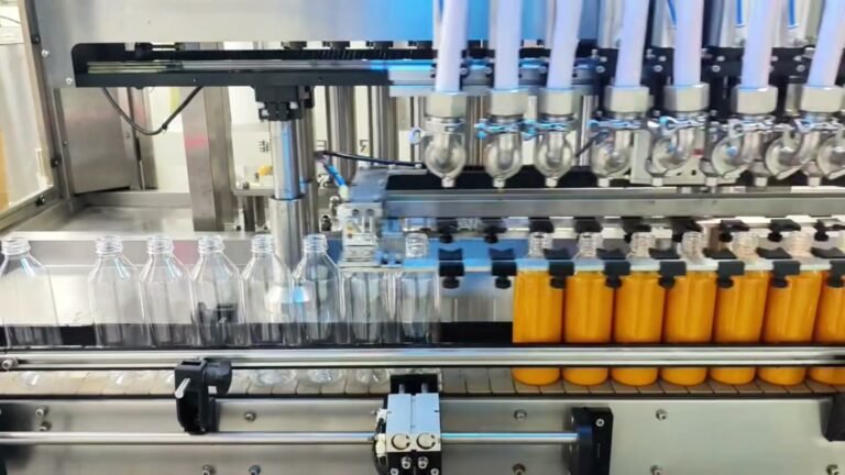 Filled mango juice bottles leaving the 10-head filling section