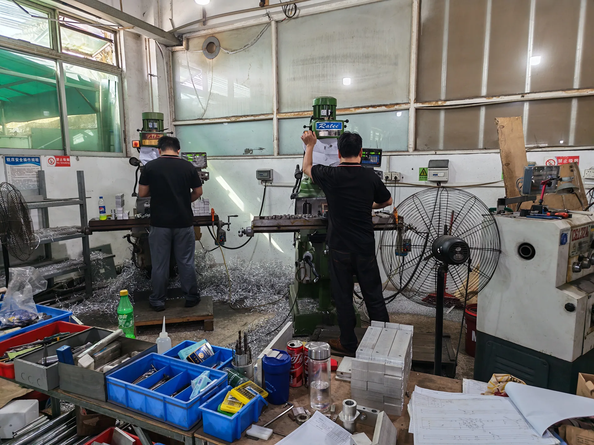 Technicians machining metal packaging machine parts in the LEKA factory
