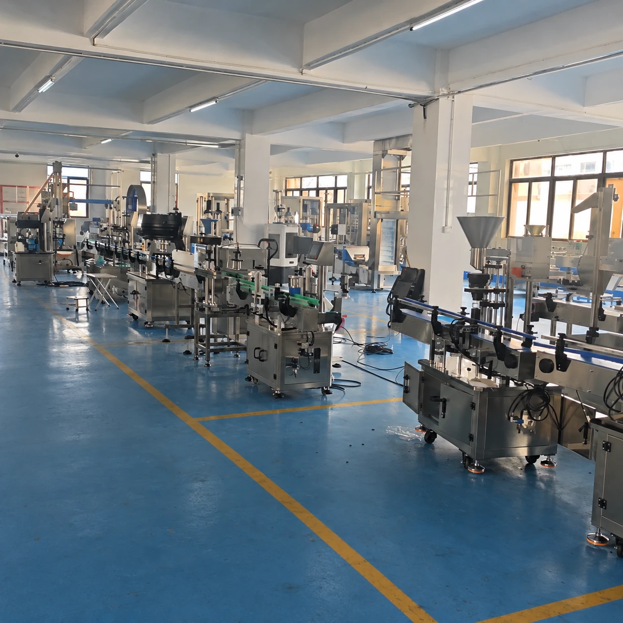 Packaging equipment and conveyors inside the LEKA workshop in Shantou